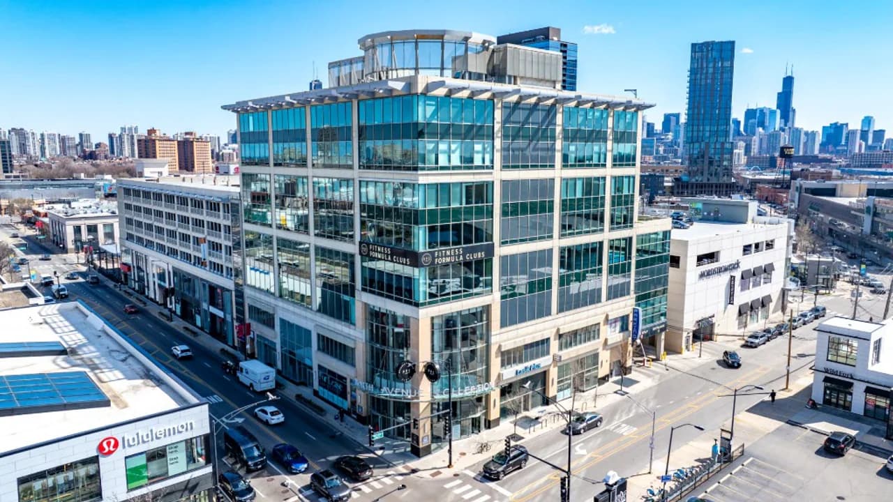 The North Avenue Collections building at North Avenue and Sheffield, home of Dental Salon's Lincoln Park office, with the Chicago skyline behind it.